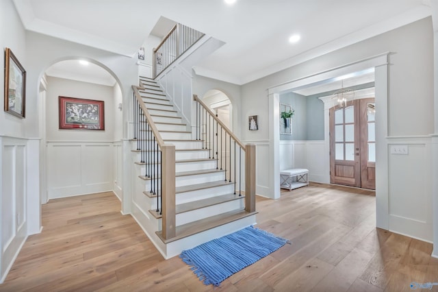13559 Monte Vedra Rd SE, Huntsville, AL 35803 - entrance foyer with a decorative wall, arched walkways, stairs, wainscoting, and wood finished floors