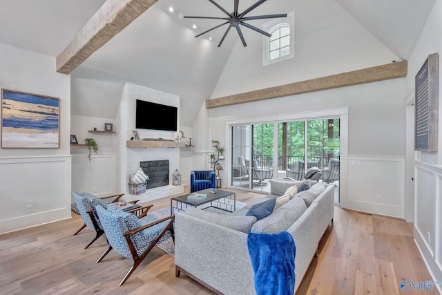 13559 Monte Vedra Rd SE, Huntsville, AL 35803 - living room with high vaulted ceiling, a glass covered fireplace, plenty of natural light, a wainscoted wall, and wood finished floors