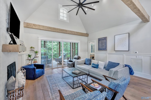 13559 Monte Vedra Rd SE, Huntsville, AL 35803 - living area featuring high vaulted ceiling, a fireplace, wainscoting, wood finished floors, and a decorative wall