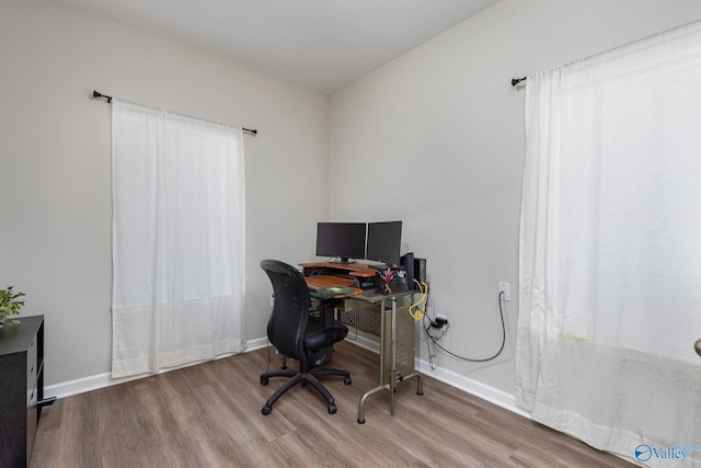 home office with hardwood / wood-style floors