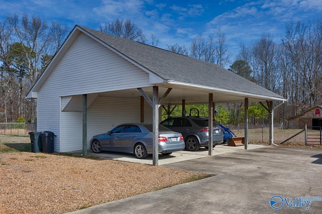 view of car parking featuring a carport and fence