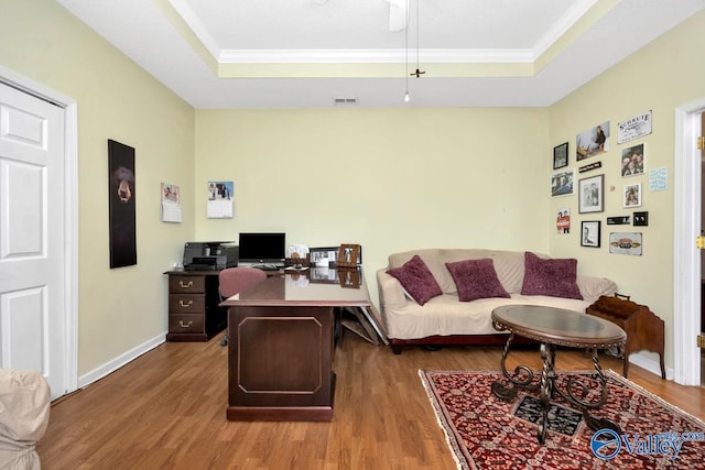 home office with wood finished floors, a raised ceiling, visible vents, and baseboards