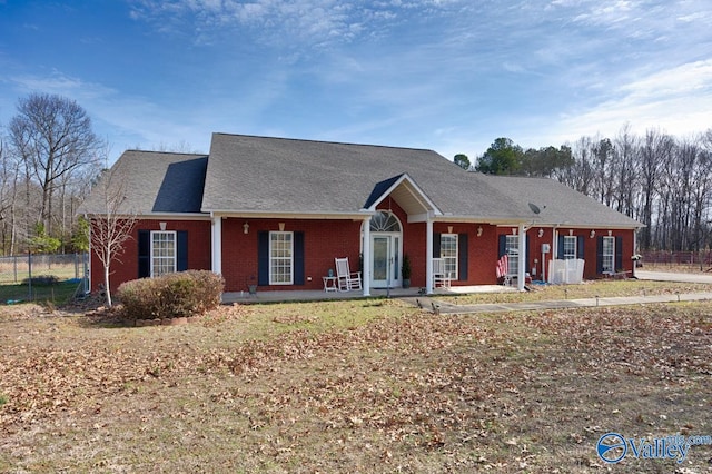 view of front of house with brick siding and fence