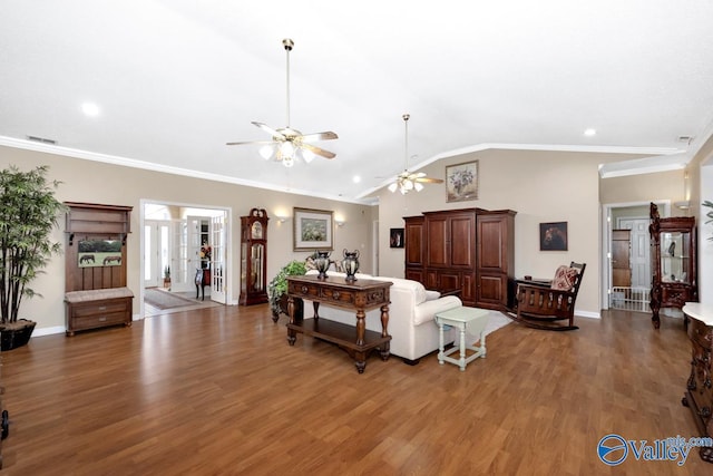 living area featuring lofted ceiling, french doors, wood finished floors, and crown molding