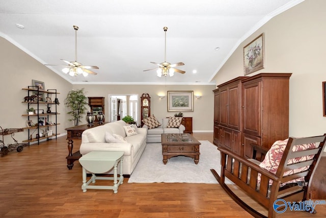 living area with a ceiling fan, baseboards, vaulted ceiling, light wood-style floors, and ornamental molding