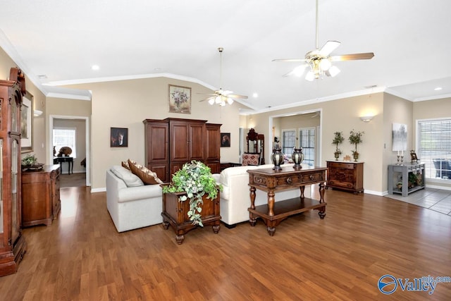 living room featuring lofted ceiling, wood finished floors, a ceiling fan, and crown molding