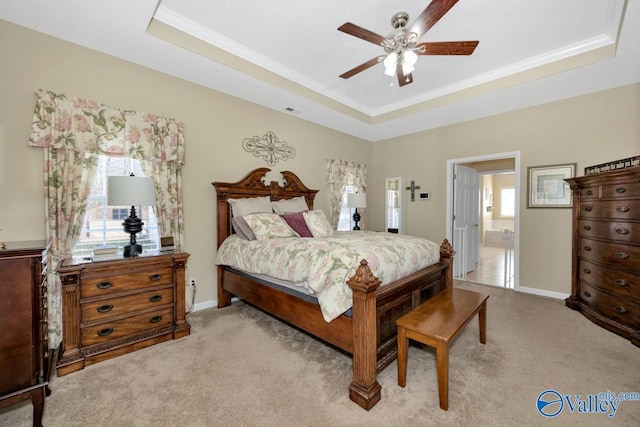 carpeted bedroom with ornamental molding, a tray ceiling, a ceiling fan, and baseboards