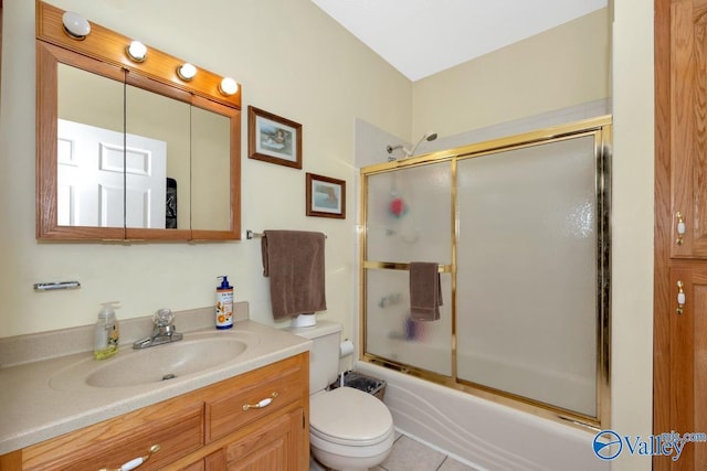 bathroom with toilet, combined bath / shower with glass door, and vanity