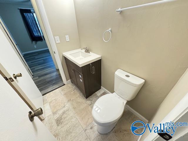2950 Hood Rd SW Unit J, Huntsville, AL 35805 - bathroom with vanity, baseboards, and toilet