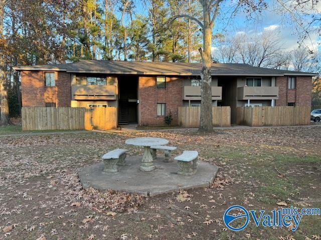 2950 Hood Rd SW Unit J, Huntsville, AL 35805 - back of property featuring fence and brick siding
