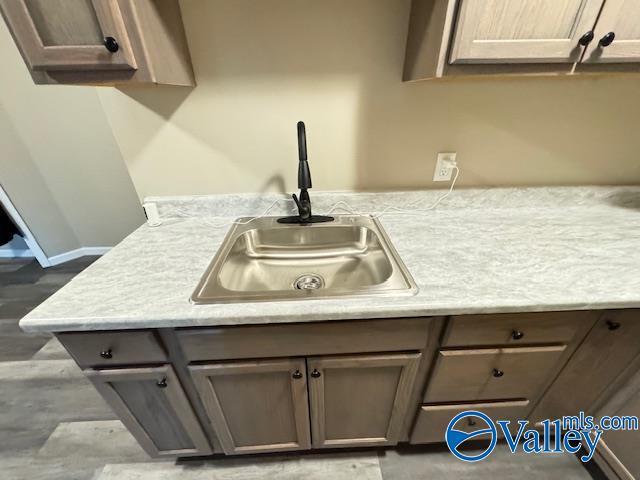 2950 Hood Rd SW Unit J, Huntsville, AL 35805 - details with baseboards, a sink, gray cabinetry, and light countertops