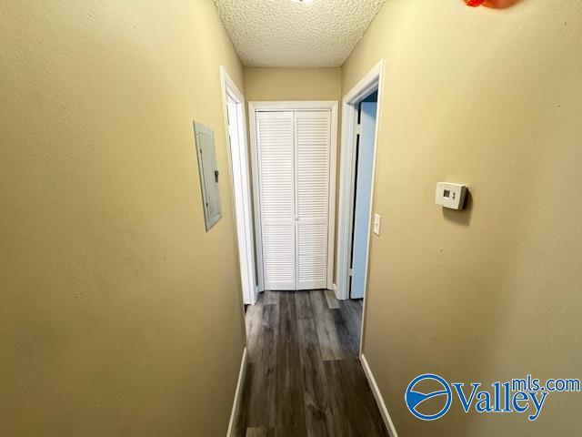 2950 Hood Rd SW Unit J, Huntsville, AL 35805 - hallway with baseboards, electric panel, dark wood-style flooring, and a textured ceiling