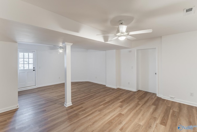 basement featuring ceiling fan, wood finished floors, visible vents, and baseboards