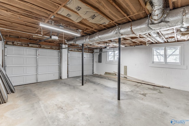 garage featuring electric panel and a garage door opener