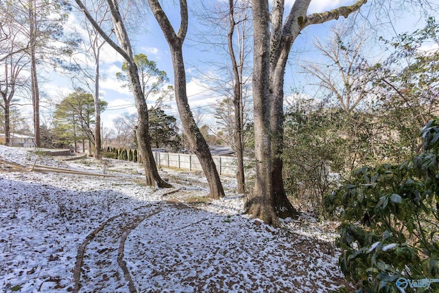 yard covered in snow with fence