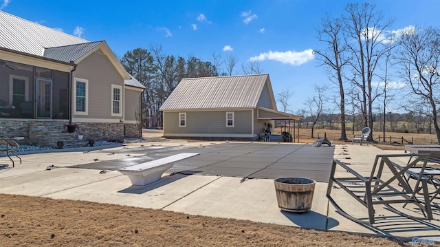 view of swimming pool with a patio, a sunroom, and a covered pool