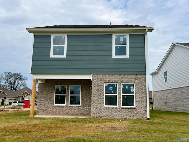 back of house featuring a yard