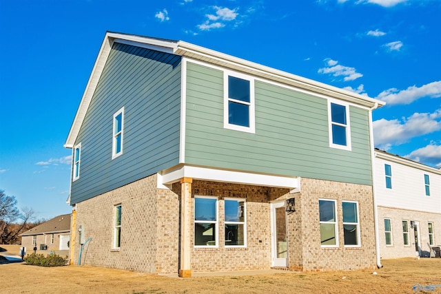 rear view of property featuring a yard