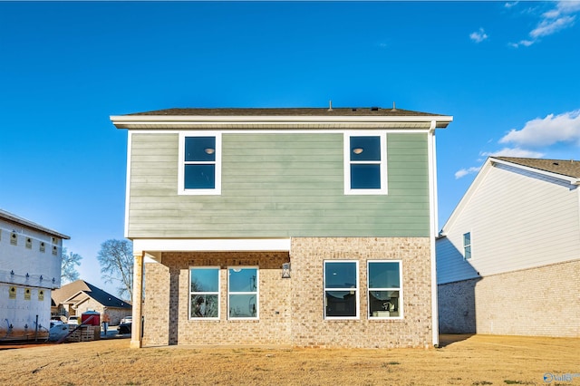 rear view of property with a yard