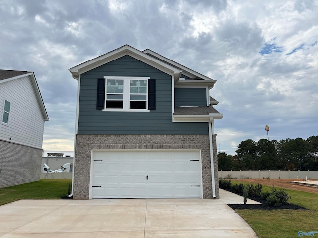 exterior space with a garage and a front lawn