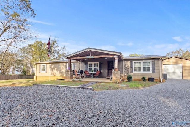 view of front of home with a patio and a garage