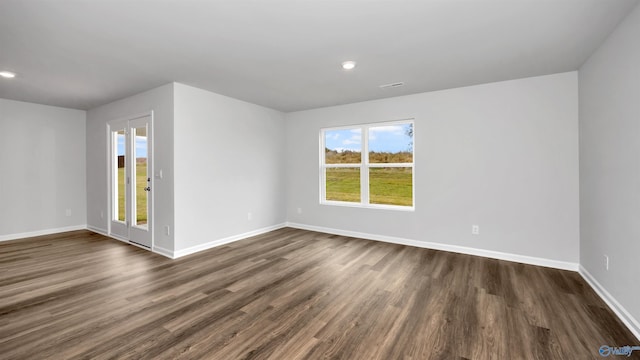 unfurnished room with dark hardwood / wood-style flooring