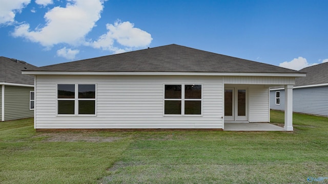 rear view of house featuring a patio and a lawn