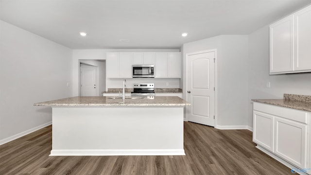 kitchen with a kitchen island with sink, sink, stainless steel appliances, and white cabinets