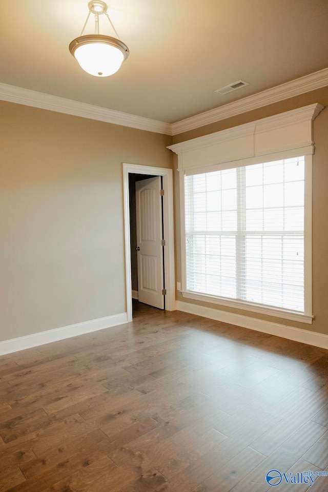 207 Somerton Dr, Huntsville, AL 35811 - unfurnished room with ornamental molding, baseboards, healthy amount of natural light, and wood finished floors
