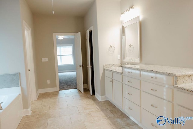207 Somerton Dr, Huntsville, AL 35811 - full bathroom with vanity, a bath, ceiling fan, and baseboards
