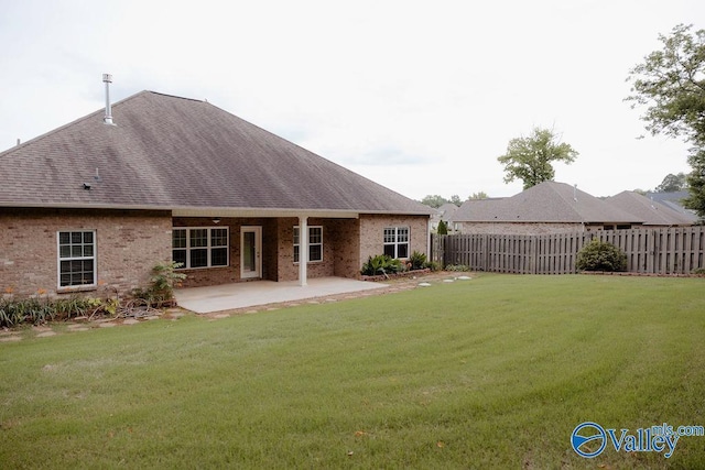 207 Somerton Dr, Huntsville, AL 35811 - back of house with a shingled roof, a patio area, and brick siding