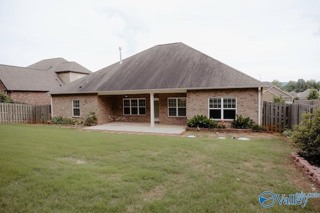 207 Somerton Dr, Huntsville, AL 35811 - rear view of property featuring a patio, brick siding, and roof with shingles