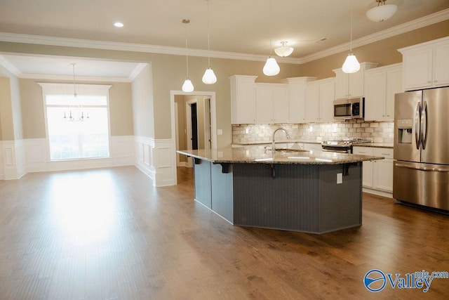 207 Somerton Dr, Huntsville, AL 35811 - kitchen featuring appliances with stainless steel finishes, a sink, light stone countertops, a kitchen breakfast bar, and white cabinetry