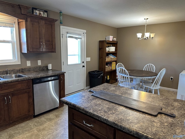 kitchen with stainless steel dishwasher, dark brown cabinets, sink, pendant lighting, and a chandelier