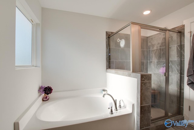 bathroom with separate shower and tub