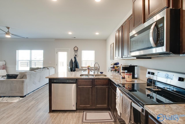 kitchen with sink, ceiling fan, dark brown cabinets, crown molding, and appliances with stainless steel finishes