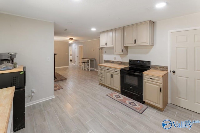 kitchen with recessed lighting, cream cabinets, light wood finished floors, and black electric range oven