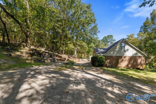 view of side of home featuring brick siding