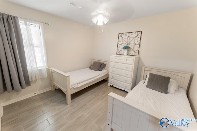 bedroom with baseboards, light wood-style floors, and visible vents