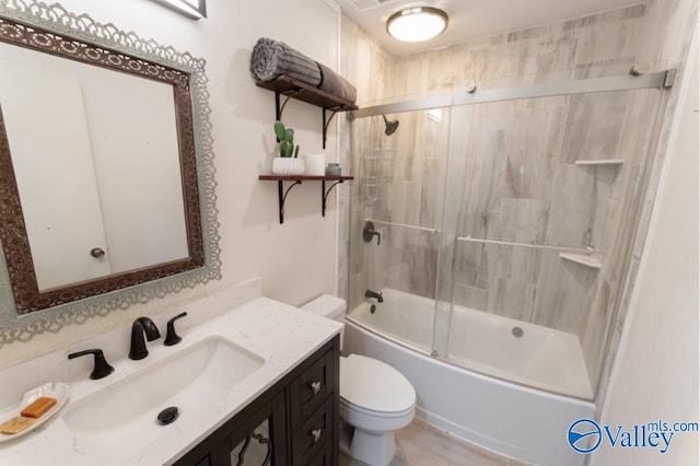 bathroom with shower / bath combination with glass door, toilet, and vanity