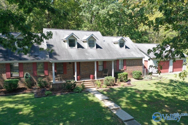 cape cod home with brick siding, a porch, and a front yard