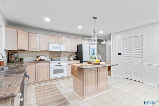 kitchen featuring light tile patterned flooring, white appliances, a sink, backsplash, and light brown cabinetry