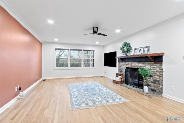 unfurnished living room with ornamental molding, a fireplace, wood finished floors, and a ceiling fan