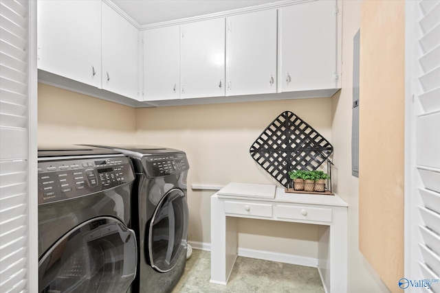 laundry room featuring washer and clothes dryer, cabinet space, and baseboards