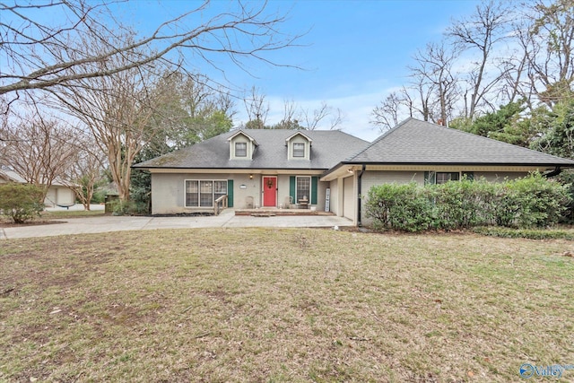 view of front facade with a shingled roof, brick siding, an attached garage, and a front lawn