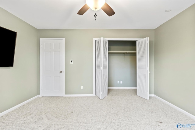 unfurnished bedroom featuring a ceiling fan, carpet, a closet, and baseboards