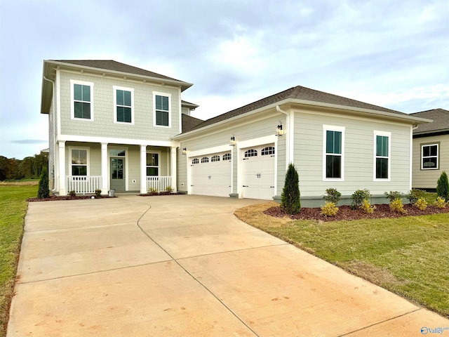 front of property featuring a porch, a garage, and a front yard