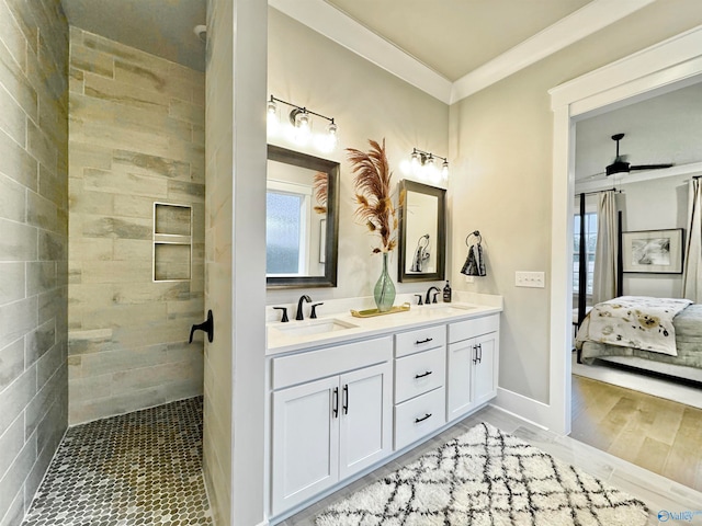 bathroom with ornamental molding, dual vanity, ceiling fan, and hardwood / wood-style floors