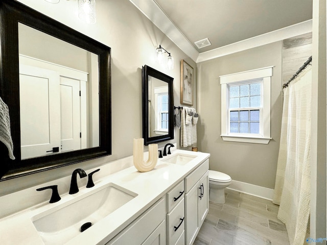 bathroom featuring dual vanity, toilet, and tile patterned flooring