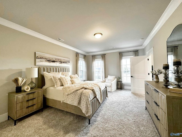 bedroom with ornamental molding and light colored carpet